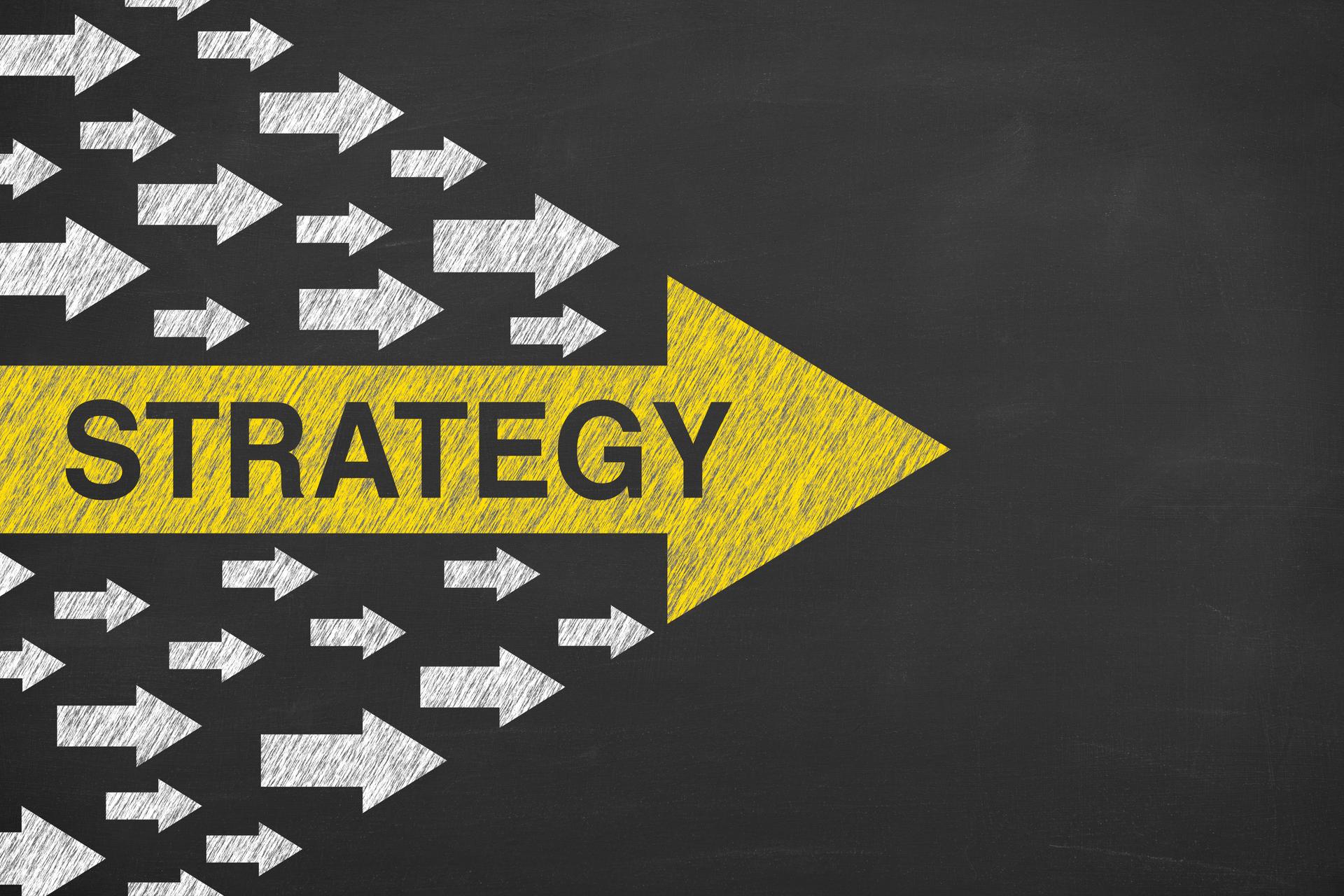 Strategy Concepts with Arrows on Chalkboard Background